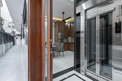 a hallway with glass doors and a dining room at Ami House 1 in Hanoi