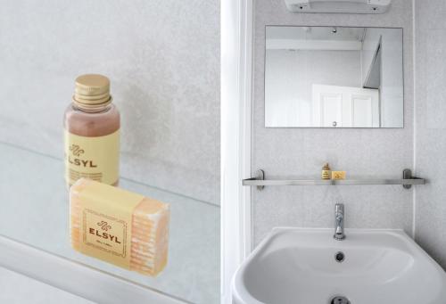 a bathroom with a sink and a bottle of soap at Sefton Park Hotel in Liverpool