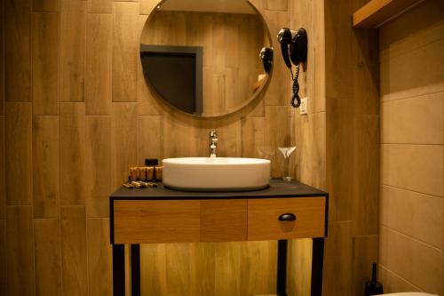 a bathroom with a sink and a mirror at Saint Thomas Holiday Village in Sozopol