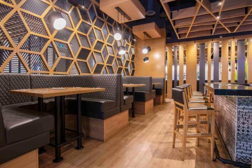 a restaurant with tables and chairs and a wall at Sandman Signature St. John's Hotel in St. John's