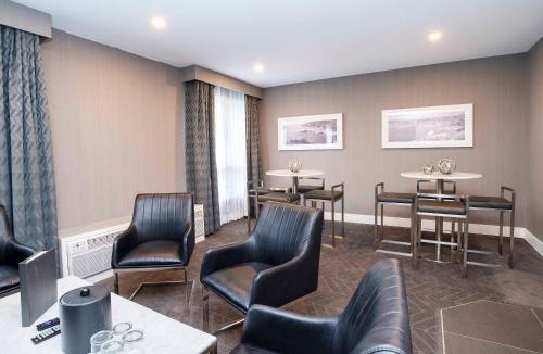 a waiting room with leather chairs and tables at Sandman Signature St. John's Hotel in St. John's