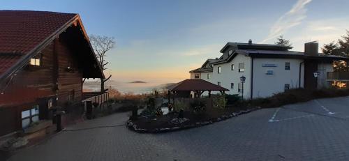 a house and a building next to a building at Apart-Hotel Kastanienhof in Dannenfels