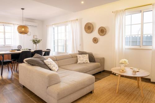 a living room with a couch and a table at Casa da Lota, by Casas do Verão in Manta Rota