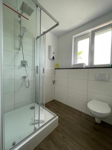 a bathroom with a shower and a toilet at Casalino in Wachtendonk