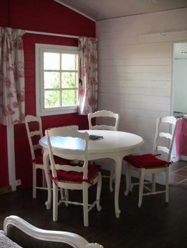 a dining room with a white table and chairs at Gîte - Chambre d Hôtes Les 4 vents Guingamp in Saint-Agathon