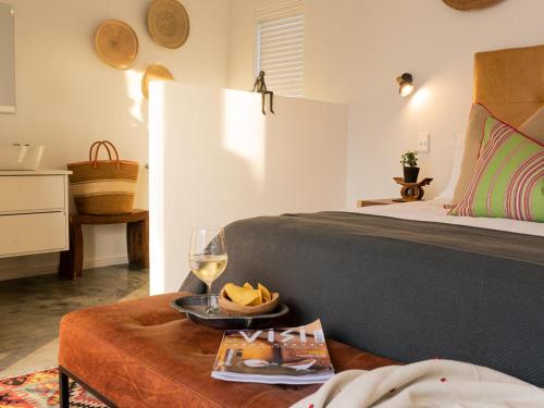een slaapkamer met een bed en een tafel met een glas wijn bij Stanford View in Stanford