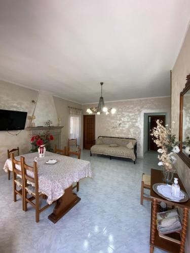 a living room with a table and a couch at La Finestra Sui Cento Portali in Pignola