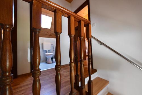 a staircase leading to a bathroom with a toilet at Mate i Jaga in Saborsko