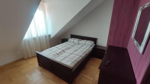 Dormitorio pequeño con cama en el ático en Apartament Prosta Kielce, en Kielce