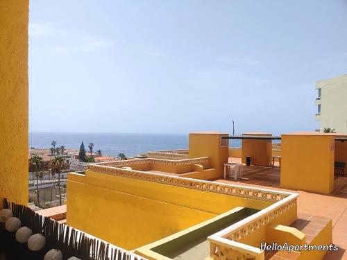 a view of the ocean from the balcony of a building at Arena Beach by HelloApartments in Puerto de Santiago