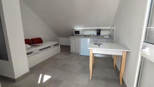 a small room with a table and a microwave at Case Vacanze Blue Sea in Mascali