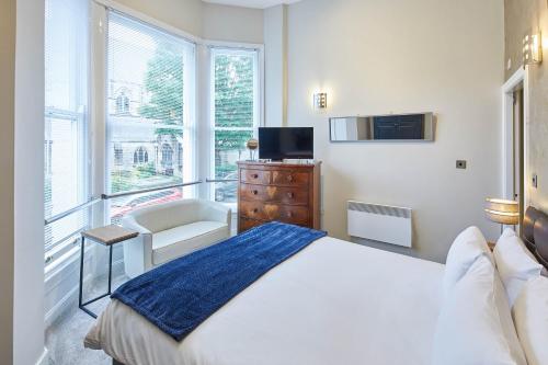 a bedroom with a bed and a tv and a window at Host & Stay - Three Bays in Scarborough