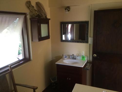 a bathroom with a sink and a mirror at NEW- Rodney Bay two bedrooms BEST VIEW 6 in Gros Islet