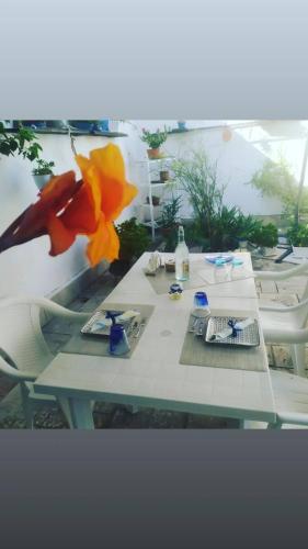 a white table with flowers on top of it at A casa di Gio in Lecce