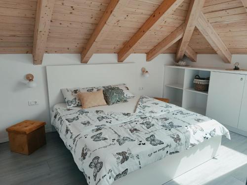 a bedroom with a bed and wooden ceilings at Villa Štorija in Split