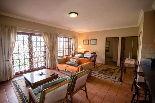 a living room with a couch and a table at Paul's Place in Dullstroom