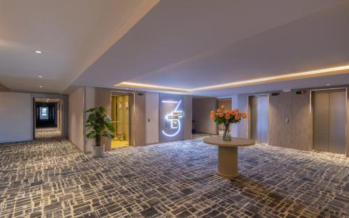 a lobby with a table with flowers on it at Campanile El Mechtel Tunis in Tunis