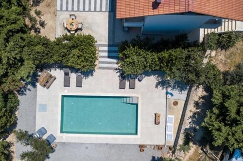 an overhead view of a swimming pool in front of a house at Villa Kora in Kallithea Rhodes