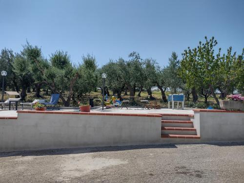 a park with tables and chairs and trees at B&B Pozzo Innamorato in Montenero di Bisaccia