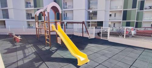 a playground with a slide on the side of a building at Lindas Holiday Apartment in Funchal