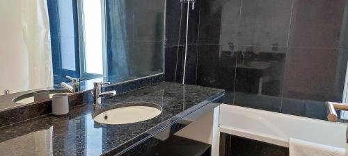 a bathroom with a sink and a mirror at Lindas Holiday Apartment in Funchal