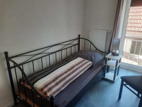 a bedroom with a bed and a tv on a table at Exklusive Wohnoase mit 3 Schlafzimmern MwSt ausweisbar großer Balkon in toller Lage von Melsungen in Melsungen