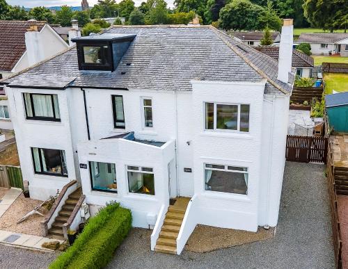 an aerial view of a white house at Amazing views across the Moray Firth, Private Suntrap Patio, 300m from the Beach, off street parking! in Nairn