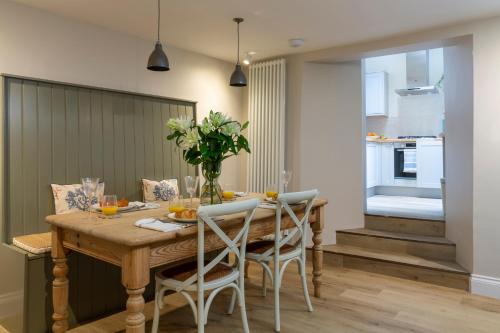 a dining room with a wooden table and chairs at Number 40 in Kingsbridge