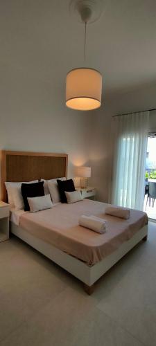 a bedroom with a large bed and a large window at Kelly's Urban Apartment in Elounda
