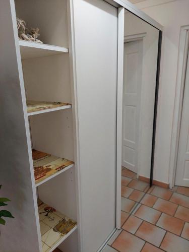 a walk in closet with a mirror and a door at Mabouya in Le Vauclin