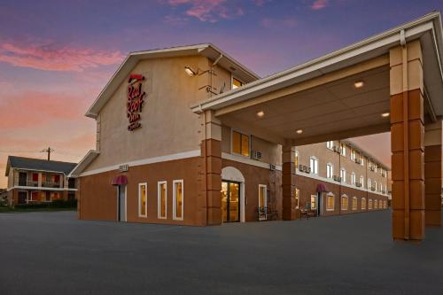 a hotel with a sign on the side of a building at Red Roof Inn & Suites Denton in Denton