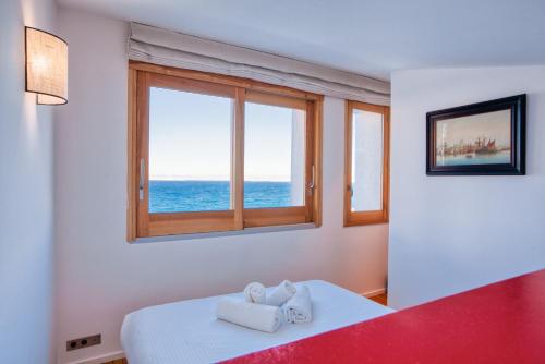 - une chambre avec 2 serviettes sur un lit et une fenêtre dans l'établissement Casa Ao - Duplex avec terrasse vue mer, à Marseille