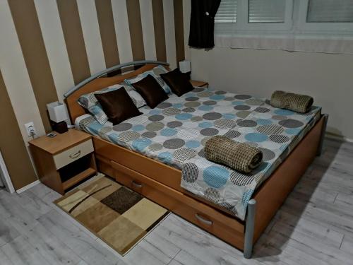 a bedroom with a bed with pillows on it at Apartman Kolubara 14 in Valjevo