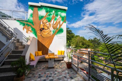 a mural of a tree on the side of a building at Zostel Rishikesh, Laxman Jhula in Rishīkesh
