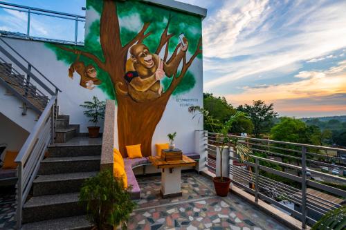 a mural of a tree on the side of a building at Zostel Rishikesh, Laxman Jhula in Rishīkesh