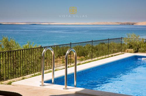 a swimming pool with a view of the water at Vista Villas - Sunny Pleasure Apartment Villa W in Ražanac