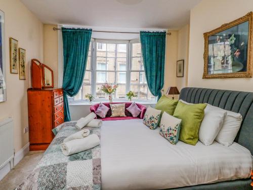 a living room with a large bed with pillows at The Town House in Dorchester