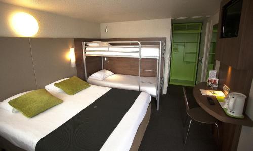 ブールジュにあるCampanile Bourges Nord - Saint-Doulchardの二段ベッド2台、デスクが備わる客室です。