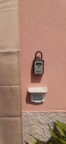 a wall with a pay meter on a pink wall at CA DU STEA in Lavagna
