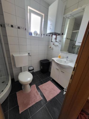 a bathroom with a toilet and a sink at Apartman Pati in Livno