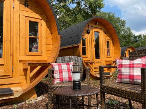 a wooden cabin with chairs and a table with a candle on it at Timmi Lake in Timmendorfer Strand