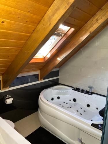 a bath tub in a bathroom with a roof at La Casina del Pozo in Bembibre