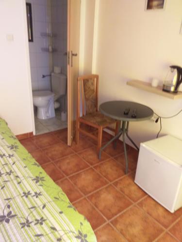 um quarto com uma mesa e uma casa de banho com um WC em Pokoje gościnne Simon em Mielno