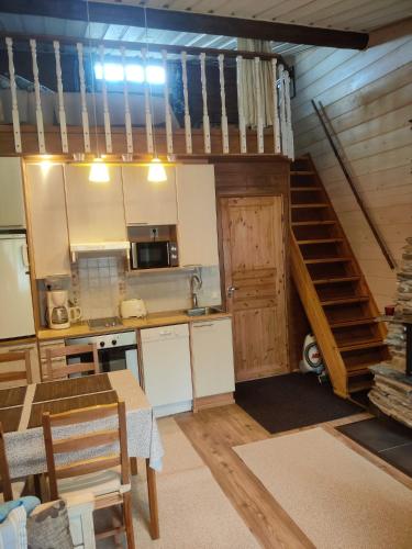 a kitchen with a staircase leading up to a loft at Rukansyli 2 in Ruka