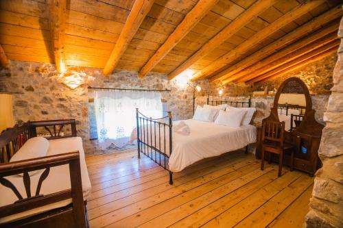 a bedroom with a bed in a stone room at Traditional Villa Askyfou in Karés