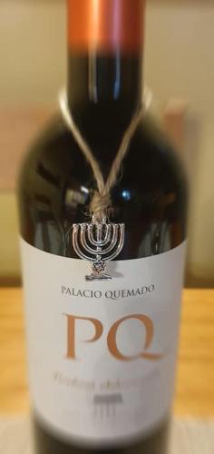 a bottle of red wine sitting on a table at Apartamento Rural Sefardí, Barrio Judío de Hervás in Hervás