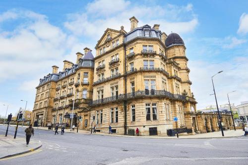 a large building on the corner of a street at The Midland Hotel in Bradford