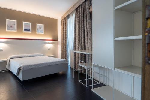 a hotel room with a bed and a mirror at Hotel Centrale in Mestre