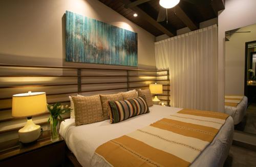 a bedroom with a large bed and two lamps at Pinnacle Resorts 180 in Puerto Vallarta