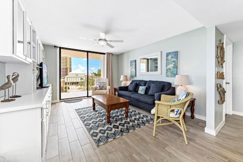 a living room with a blue couch and a table at Compass Point 310 in Gulf Shores